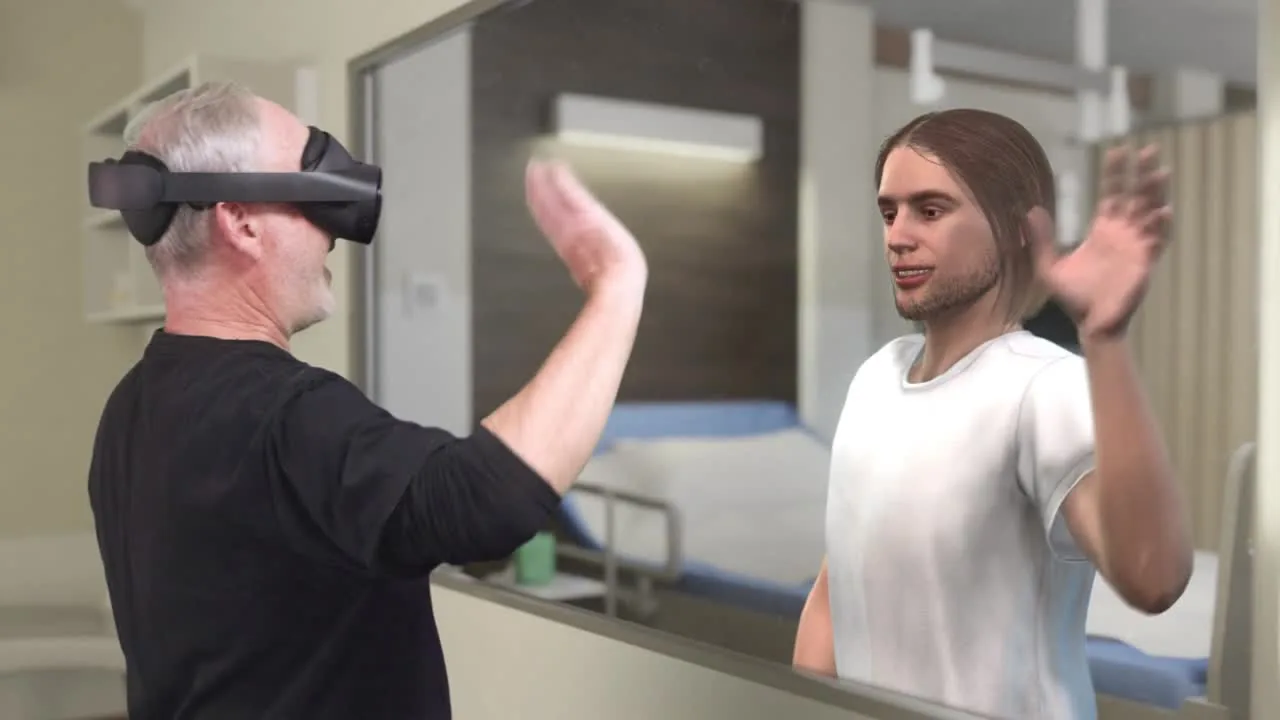 A man wearing a mixed-reality headset raises his hands, mirrored by a long-haired figure, in a simulated hospital room.