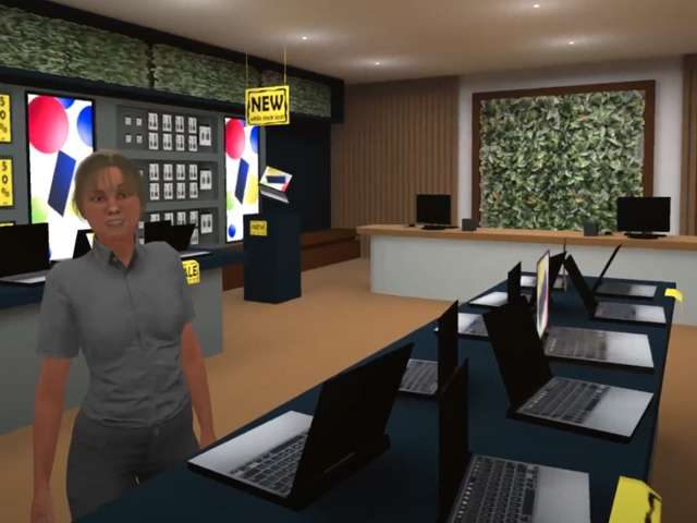 A VR shopping-centre electronics store scene, with an avatar standing among laptop and screen displays, from the Central Coast Council disability-awareness experience.