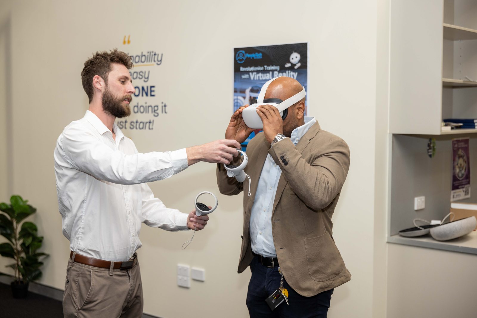 A person being fitted with a PTR-branded Meta Quest 2 headset at a live event, with PTR's robot-character poster in the background