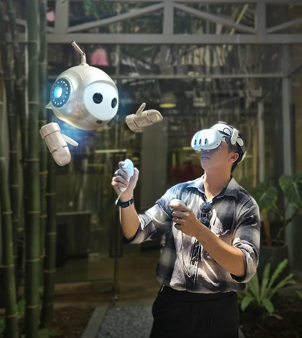 A man wearing a Meta Quest 3 headset raises two controllers while Peter, PTR's white and gold in-VR robot guide, floats beside him in a warmly lit workshop