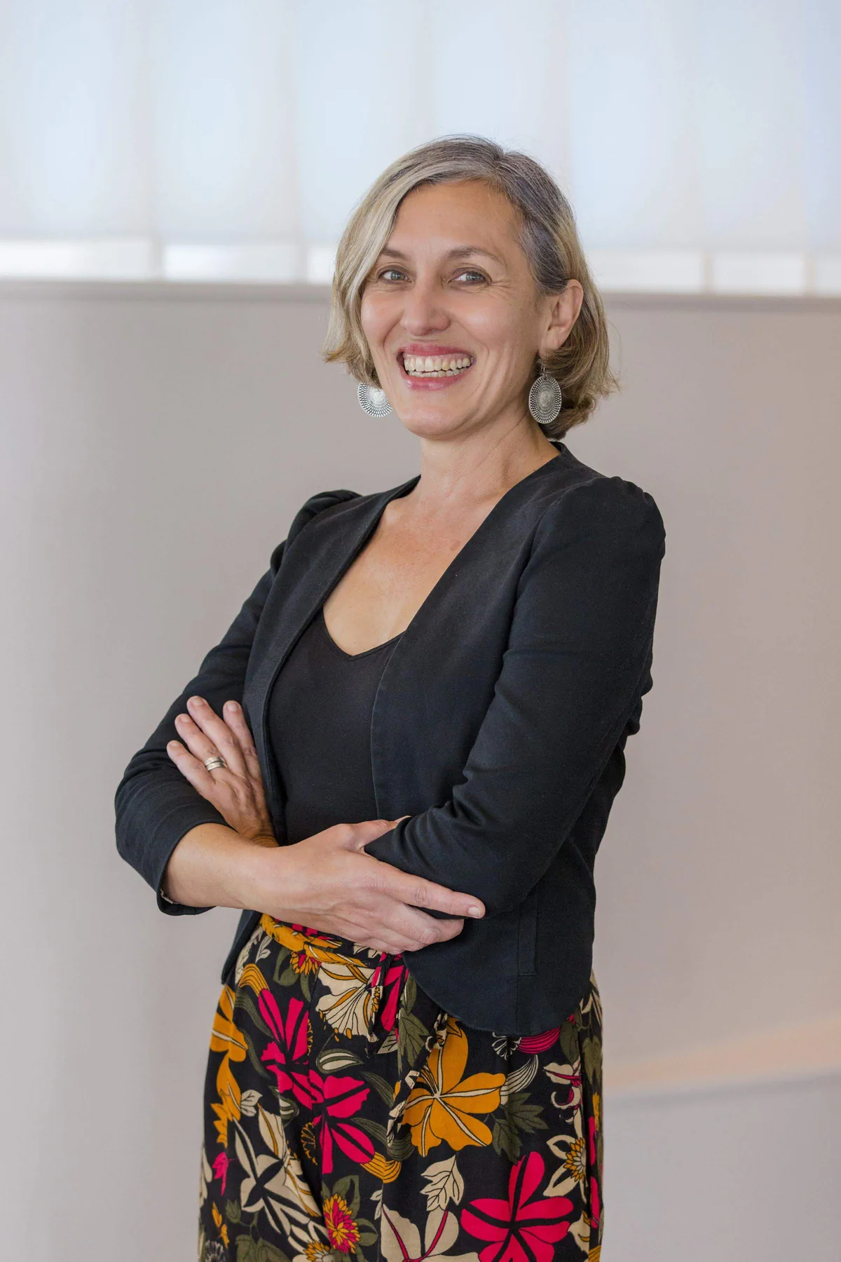 Leonie Sanderson, PTR's co-founder, arms folded and laughing.