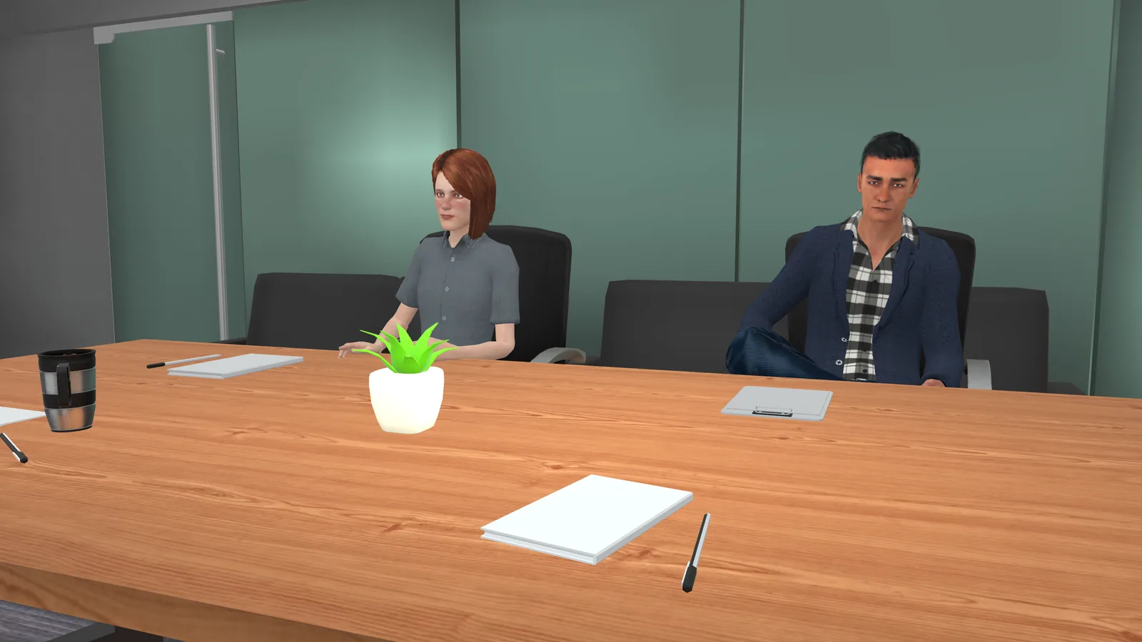 Everyday Inclusion: two colleagues seated at a meeting room table, notepads and a pot plant in front of them.